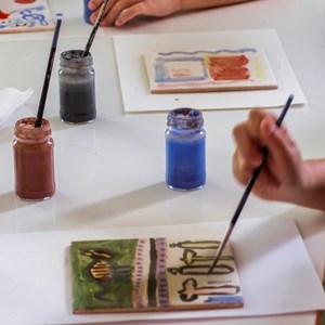 Oficina «Como se faz uma bandeira». Bandeiras criadas em azulejo com pincéis e tintas de água.